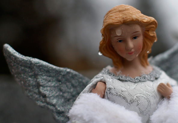 Rain drops are seen on a figurine of an angel at a makeshift memorial to the victims of the Sandy Hook Elementary School shootings in Newtown, Conn., Dec. 17. The small Connecticut town shattered by an act President Barack Obama called "unconscionable ev il," was preparing for the first of 20 funerals for schoolchildren massacred in their classrooms last week. (CNS photo/Mike Segar, Reuters)