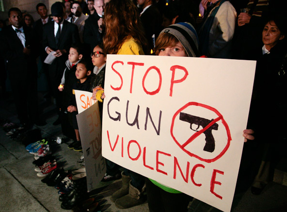 Sophie Bell, 9, holds a sign during an interfaith prayer vigil to end gun violence Dec. 19 in front of Los Angeles City Hall. (CNS photo/Jason Redmond, Reuters)