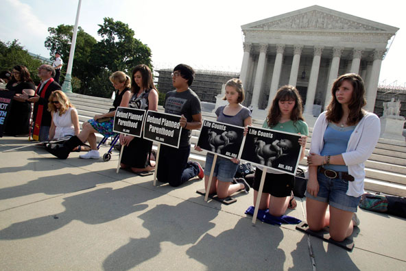 Pro-life activists rally in front of U.S. Supreme Court in Washington June 25. The court announced the same day it will issue all remaining decisions for the current term June 28, including its ruling on four cases related to the health care reform law. (CNS photo/Yuri Gripas, Reuters)