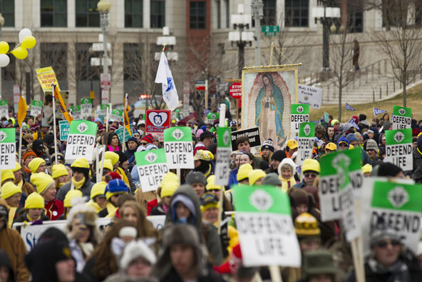 Demonstrators make their way toward the Supreme Court building during the March for Life in Washington Jan. 25. Bitter cold and snow did not stop tens of thousands of people from marching against abortion for the 40th year since the Supreme Court decisio n in Roe v. Wade. (CNS photo/Daniel Sone) 