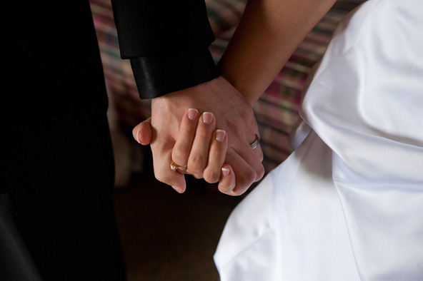 A groom and bride hold hands on their wedding day. The U.S. Supreme Court announced Dec. 7 that it will hear two cases challenging federal and state laws that define marriage as a union of a man and a woman. (CNS file photo by Jon L. Hendricks)