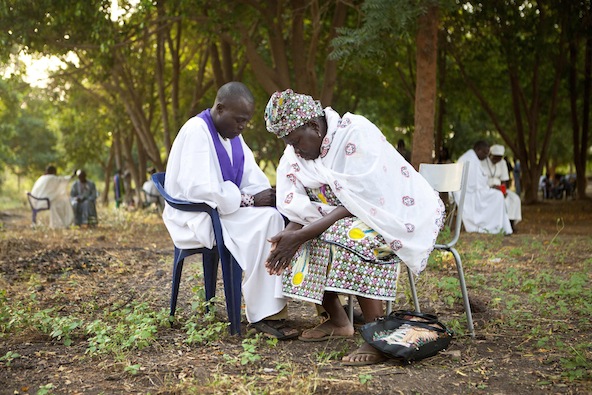 A priest hears confession from a woman during an outdoor Mass at the annual Catholic pilgrimage in the town of Kita, western Mali Nov. 17. Nearly 7,000 pilgrims participated in the two-day celebration, lead by Archbishop Jean Zerbo of Bamako, Mali. (CNS photo/Malin Palm, Reuters)