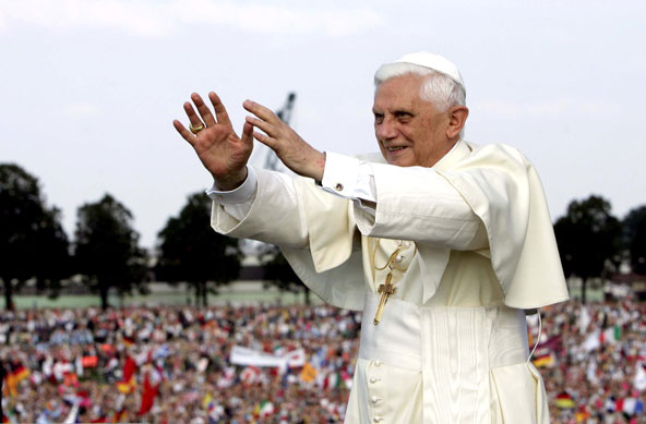 Pope Benedict XVI responds to the cheers of World Youth Day pilgrims as he cruises in a boat down the Rhine River in Cologne in 2005. The pope announced Feb. 11 that he will resign at the end of the month. The 85-year-old pontiff said he no longer has th e energy to exercise his ministry over the universal church. (CNS photo/Reuters)