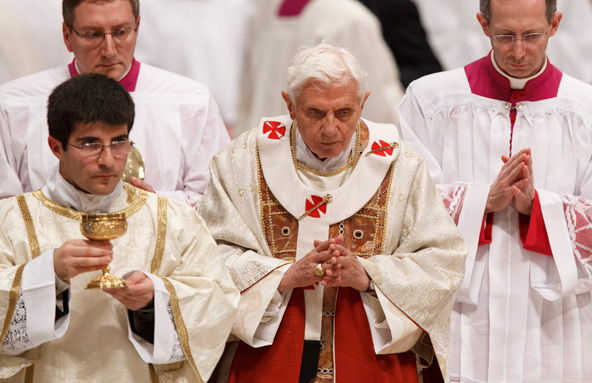 A server carries the Eucharist as Pope Benedict XVI walks to distribute Communion during Mass marking the feast of the Presentation of the Lord and World Day for Consecrated Life in St. Peter's Basilica at the Vatican in this Feb. 2 file photo. The pope announced Feb. 11 that he will resign at the end of the month. Recently the pope stopped carrying the Eucharist as he walked to distribute Communion. (CNS photo/Paul Haring)