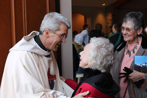 Fr. Pat Mowrer greets parishioners after the Feb. 2 dedication Mass.