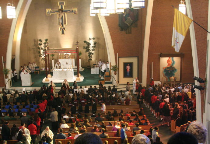 Phoenix's bishops Eduardo A. Nevares and Thomas J. Olmsted (top) and Bishop James S. Wall of Gallup and Gerald F. Kicanas of Tucson (bottom) distribute communion during the annual all-school Mass at Ss. Simon and Jude Cathedral in honor of Catholic Schools Week. (Ambria Hammel/CATHOLIC SUN)