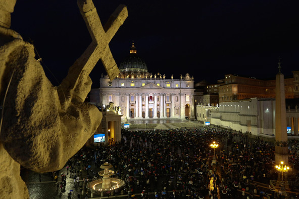 A crowd gathers during the conclave in St. Peter's Square at the Vatican March 12. Despite the rain, thousands of people filled the square on the first evening of the conclave to witness the black smoke that signaled the Catholic Church's 115 cardinal el ectors had failed, as expected, to elect a pope on the first ballot. (CNS photo/Alessandro Bianchi, Reuters)
