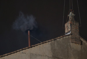 Black smoke billows from the chimney of the Sistine Chapel, the sign that cardinals did not elect a pope in their first round of balloting March 12 at the Vatican. (CNS/Paul Haring)