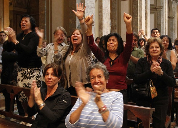 People celebrate election of new pope at Metropolitan Cathedral in Buenos Aires, Argentina, March 13. The world's cardinals, meeting in conclave at the Vatican, elected as pope Cardinal Jorge Mario Bergoglio of Buenos Aires. The 76-year-old Jesuit is the first Latin American pope. (CNS photo/Enrique Marcarian, Reuters)