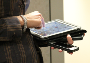 A woman switches between applications on her iPad after white smoke appeared from the temporary smokestack atop the Sistine Chapel March 13. Social media and online sites played a large role in the conclave. (Ambria Hammel/CATHOLIC SUN)