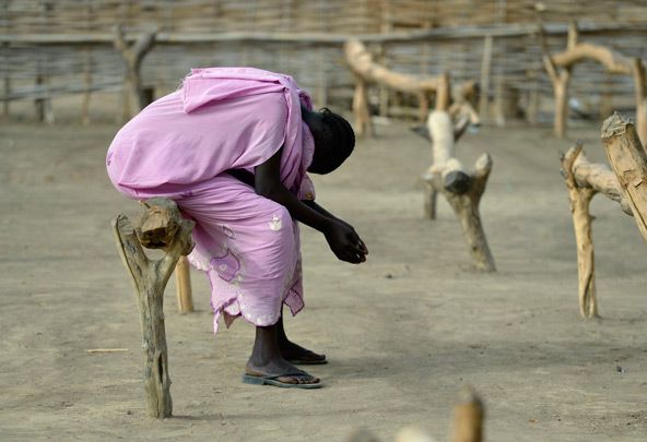 A displaced young woman prays in the makeshift Catholic chapel in Agok, a town in the contested Abyei region where tens of thousands of people fled in 2011 after an attack by soldiers and militias from Sudan. (CNS photo/Paul Jeffrey)