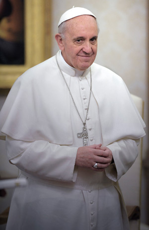 Pope Francis smiles during a private audience with Andry Nirina Rajoelina, president of the High Transitional Authority of Madagascar, in his private library at the Vatican April 26. (CNS photo/Stefano Spaziani)