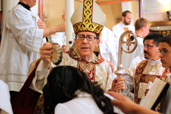 Bishop Thomas J. Olmsted welcomed new Catholics into the Church during the Easter Vigil at Ss. Simon and Jude Cathedral. (J.D. Long-Garcia/CATHOLIC SUN)