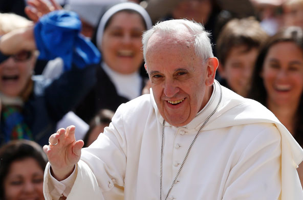 Pope Francis greets the crowd as he arrives to lead his general audience in St. Peter's Square at the Vatican May 22. (CNS photo/Paul Haring)