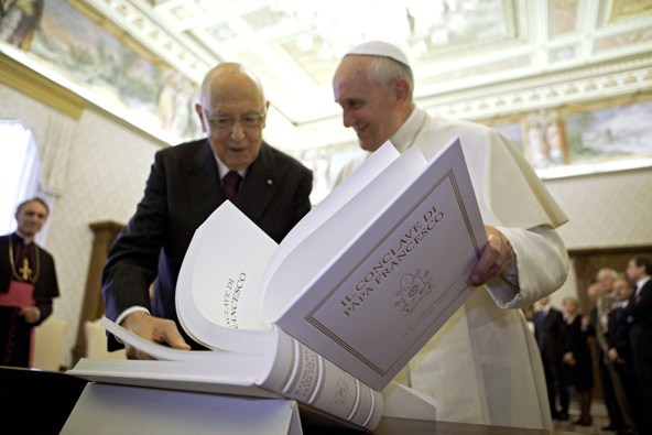 Pope Francis looks over a book with Italian President Giorgio Napolitano during a private meeting at the Vatican June 8. (CNS photo/Maria Grazia Picciarella, pool)
