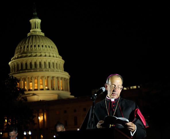 Archbishop William E. Lori of Baltimore leads prayer during a candlelight vigil for the second annual Fortnight for Freedom observance outside the U.S. Capitol in Washington June 22. The campaign, initiated by the U.S. bishops in 2012, calls for a two-w eek period of prayer, education and action on preserving religious freedom in the U.S. The observance ends July 4, Independence Day. (CNS photo/Leslie E. Kossoff)