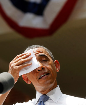 U.S. President Barack Obama pauses and wipes his forehead as he talks about his vision to reduce carbon pollution June 25 during a speech at Georgetown University in Washington. (CNS photo/Larry Downing, Reuters)