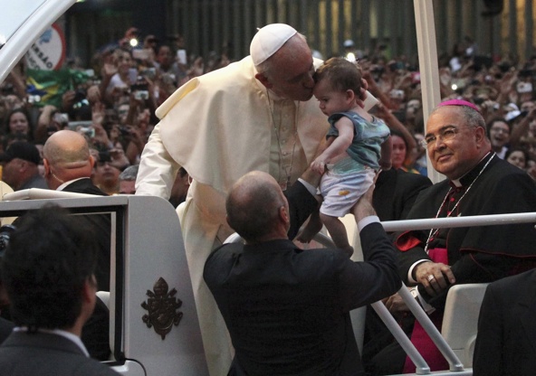 Pope Francis kisses a baby after arriving in Rio de Janeiro July 22. The pope is making his first trip outside Italy to attend World Youth Day, the international Catholic youth gathering. (CNS photo/Ana Carolina Fernandes, Reuters)