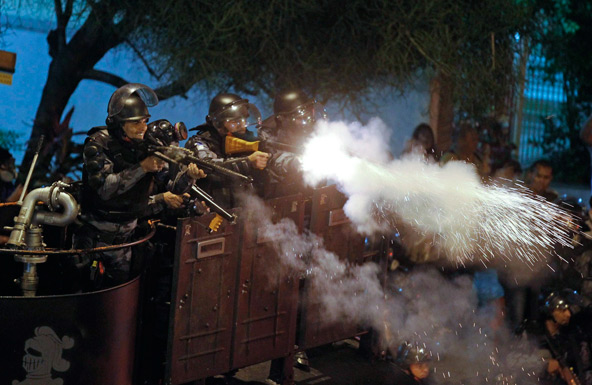 Riot police fire rubber bullets at demonstrators during clashes near Rio de Janeiro's Guanabara Palace, where Pope Francis met with Brazilians politicians July 22. Demonstrators are continuing their anti-government protests, which began in June amid grow ing economic and social dissatisfaction in Brazil. (CNS photo/Pilar Olivares, Reuters)