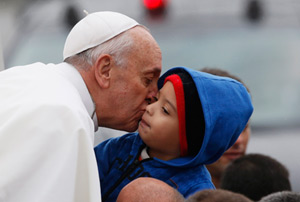 Pope Francis greets pilgrims as he arrives at Brazil's Basilica of the National Shrine of Our Lady of Aparecida July 24. During his visit, the pope entrusted World Youth Day to Mary's maternal protection, but also challenged parents, priests and other ad ult Catholics to give the young people things that the world, with all its wealth, cannot: faith and values. (CNS photo/Nacho Doce, Reuters)