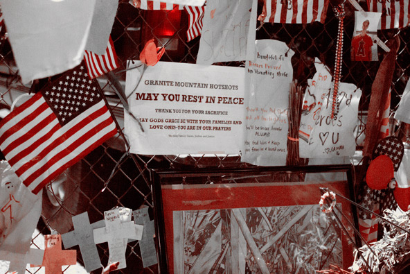 Nineteen hotshot firemen lost their lives June 30 battling the fire. Mourners made a makeshift memorial for the firefighters on a chain-link fence across from Granite Mountain Interagency Hot Shot Crew firehouse in Prescott. (J.D. Long-García/CATHOLIC SUN)