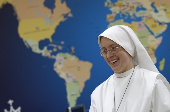 Sister Kristen Gardner talks in front of a world map in the communications office at the World Youth Day headquarters in Madrid in this 2010 file photo. (CNS photo/Paul Haring)