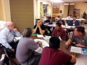 Deacon Jim Trant (far left) and Deacon Ron Poulin (far right) discuss with other Blackfeet men in Cursillo.