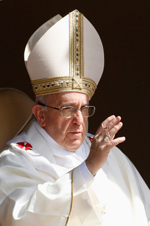 Pope Francis gives blessing after celebrating a Mass Aug. 15 for the feast of the Assumption of Mary in the main square of Castel Gandolfo, a small town in the hills near Rome where previous popes have spent the summer months. (CNS photo/Giampiero Sposit o, Reuters)