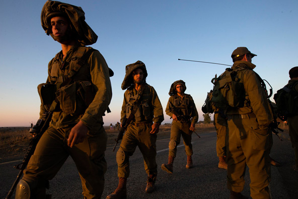 Israeli soldiers take part in a drill in the Israeli-occupied Golan Heights in the early morning hours of Aug. 30. Israel ordered a small-scale mobilization of reservists and strengthened its missile defenses as precautions against possible Syrian attack should Western powers carry out threatened strikes on Syria. (CNS photo/Ronen Zvulun)