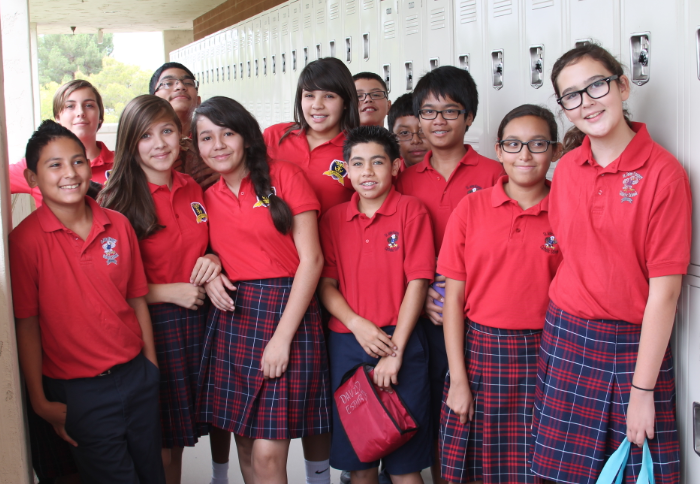Junior high students pose for a picture outside of St. John Vianney's new lockers Aug. 23. Annunciation Catholic School students also received lockers for the first time. (Ambria Hammel/CATHOLIC SUN)