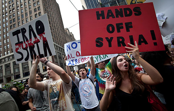 Demonstrators protest against proposed U.S. military action against Syria in Times Square in New York Aug. 31. Even with just war theory as a guide, analysts say the answers remain murky to moral and ethical questions about whether a military strike is t he appropriate response to what U.S. officials believe was a chemical weapons attack on Syrian civilians. (CNS photo/Carlo Allegri, Reuters)
