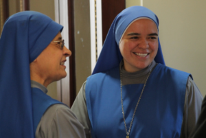 Servants of the Lord and the Virgin of Matará who serve at St. Anthony and Immaculate Heart of Mary parishes in Phoenix, talk with Fr. David Sanfilippo, vicar for priests Sept. 11 after a Mass to formally welcome newly arrived religious and clergy to the Diocese of Phoenix (Ambria Hammel/CATHOLIC SUN)