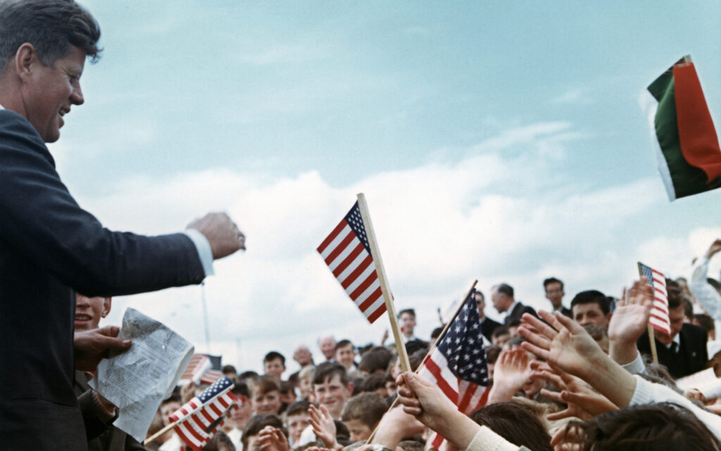 U.S. President John F. Kennedy greets the crowd June 27, 1963, in the town of New Ross in County Wexford, Ireland. The Irish-American, who was the first Catholic to become U.S. president, was proud of his Irish roots, and huge crowds greeted him wherever he went on a visit to his ancestral homeland nearly 50 years ago. (CNS photo/Robert Knudsen, White House, courtesy John F. Kennedy Presidential Library and Museum)