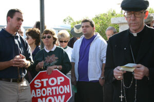 Bishop Olmsted prays in front of an abortion clinic Dec. 24, 2003, days after his installation as bishop of Phoenix.