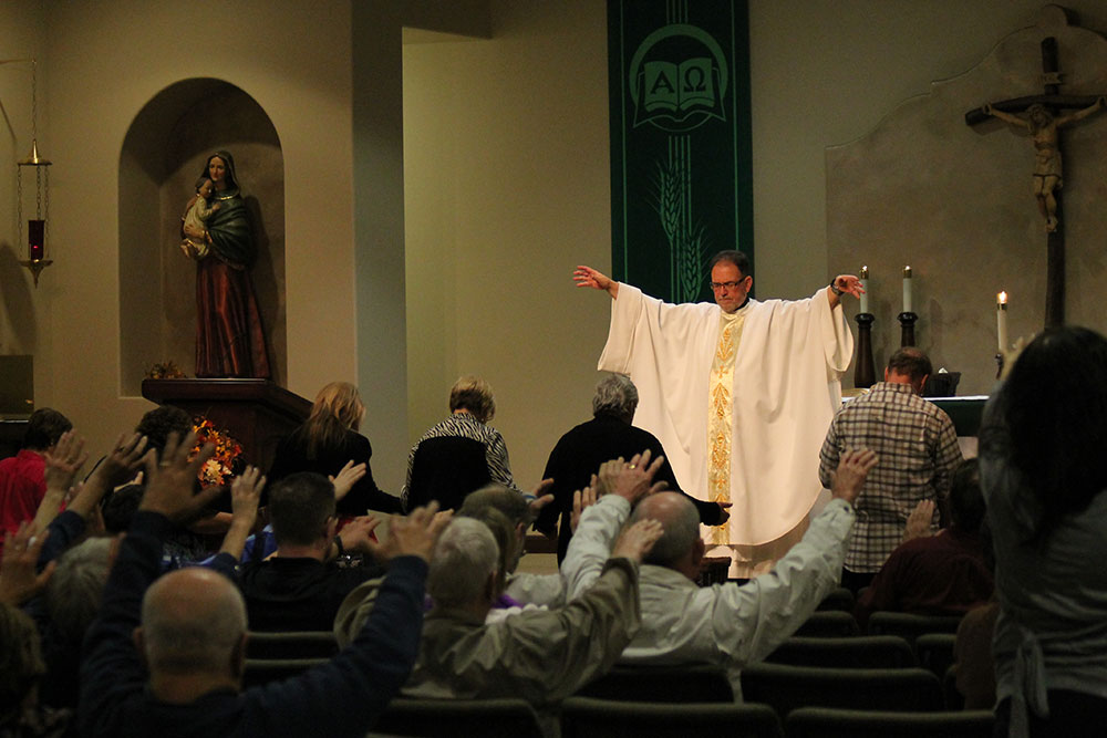 Ambria Hammel/CATHOLIC SUN Maryknoll Father Scott Harris prays over Catholics during a Nov. 21 Healing Mass at St. Rose Philippine Duchesne Parish in Anthem that Catholic Renewal Ministries sponsors year-round. (Ambria Hammel/CATHOLIC SUN)