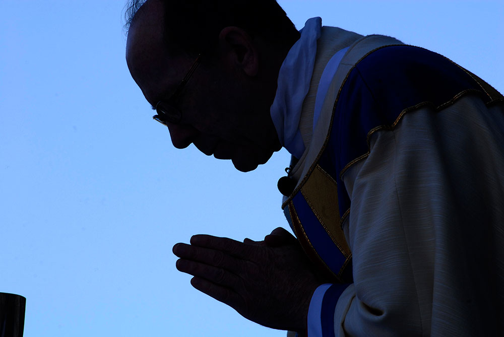 Bishop Thomas J. Olmsted bows during the consecration at the Dec. 7 Honor Your Mother Mass in downtown Phoenix. (Tamara Tirado/CATHOLIC SUN)