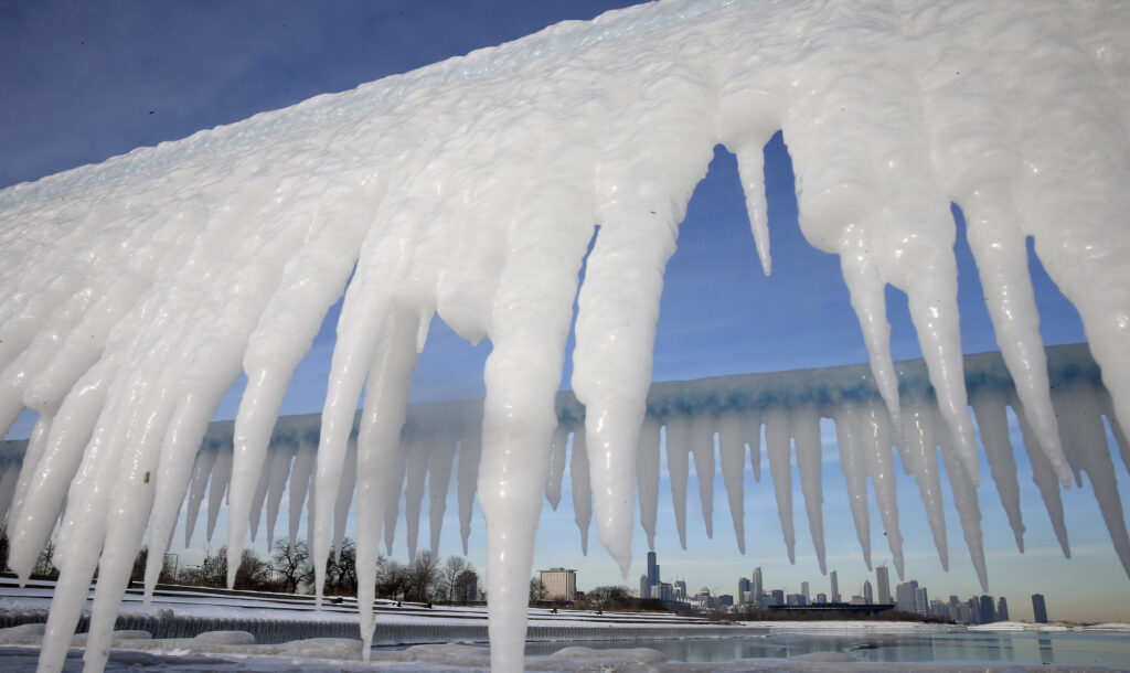The Chicago skyline is framed by icicles Jan. 8. A deadly blast of arctic air shattered decades-old temperature records, snarling air, road and rail travel, driving energy prices higher and overwhelming shelters for homeless people. (CNS photo/Jim Young, Reuters)