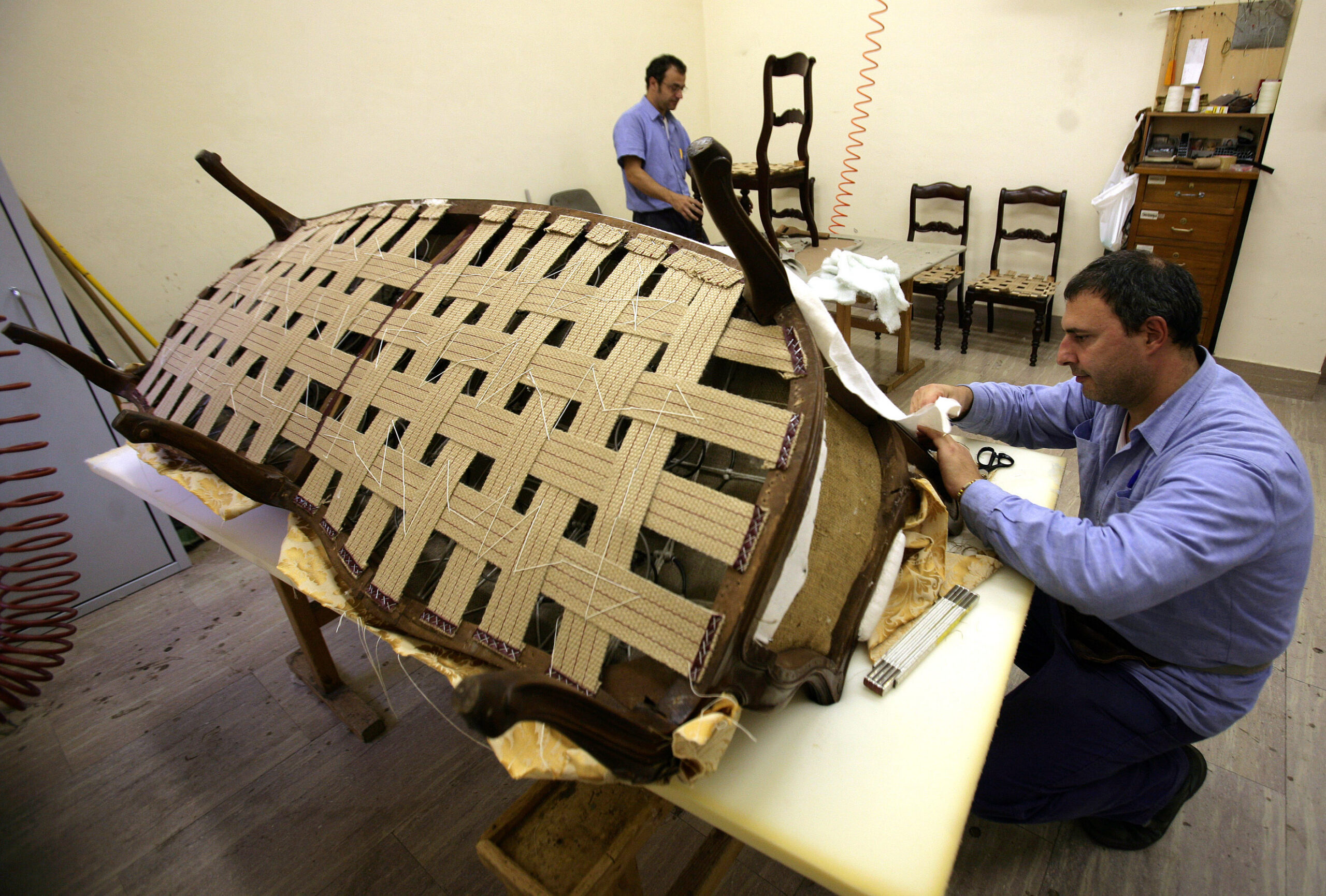 Workers repair furniture in a workshop of the "Floreria" at the Vatican in this Oct. 17, 2008 file photo. The Floreria is the Vatican agency tasked with preparing for every papal audience and ceremony. They also furnish Vatican offices and apartments, among other duties. (CNS photo/Alessia Giuliani)