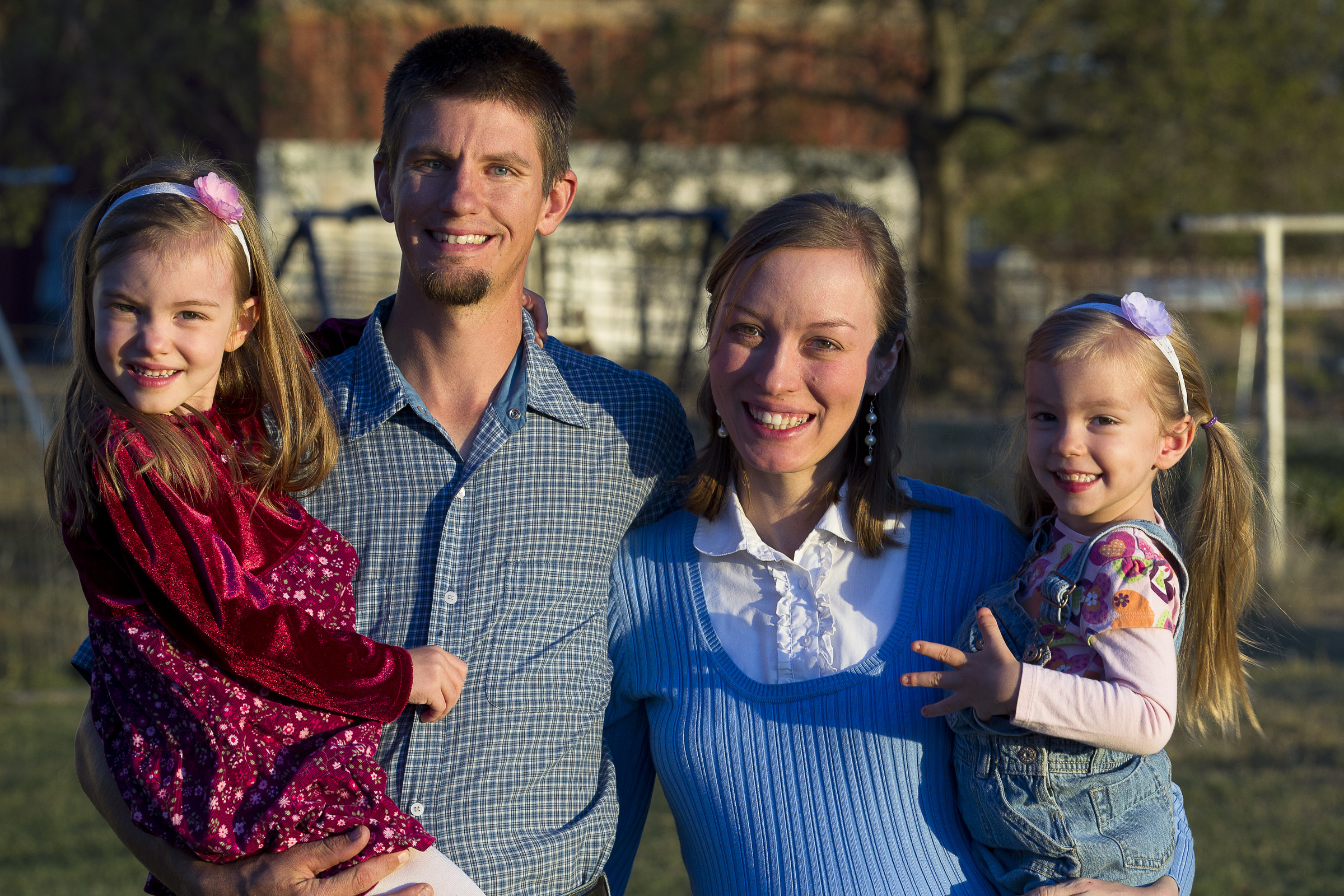 Family in St. Leo, Kan., pose for photo outside their home on a farm Kevin and Mary Ford pose for a photo with their children outside their Kansas home. "I want to be a witness to what marriage can be, what family can be and what life on the land can be," Kevin said about his determination to make rural life sustainable." It's a beautiful reality. It's hard but it's beautiful." (CNS photo/Tyler Orsburn)