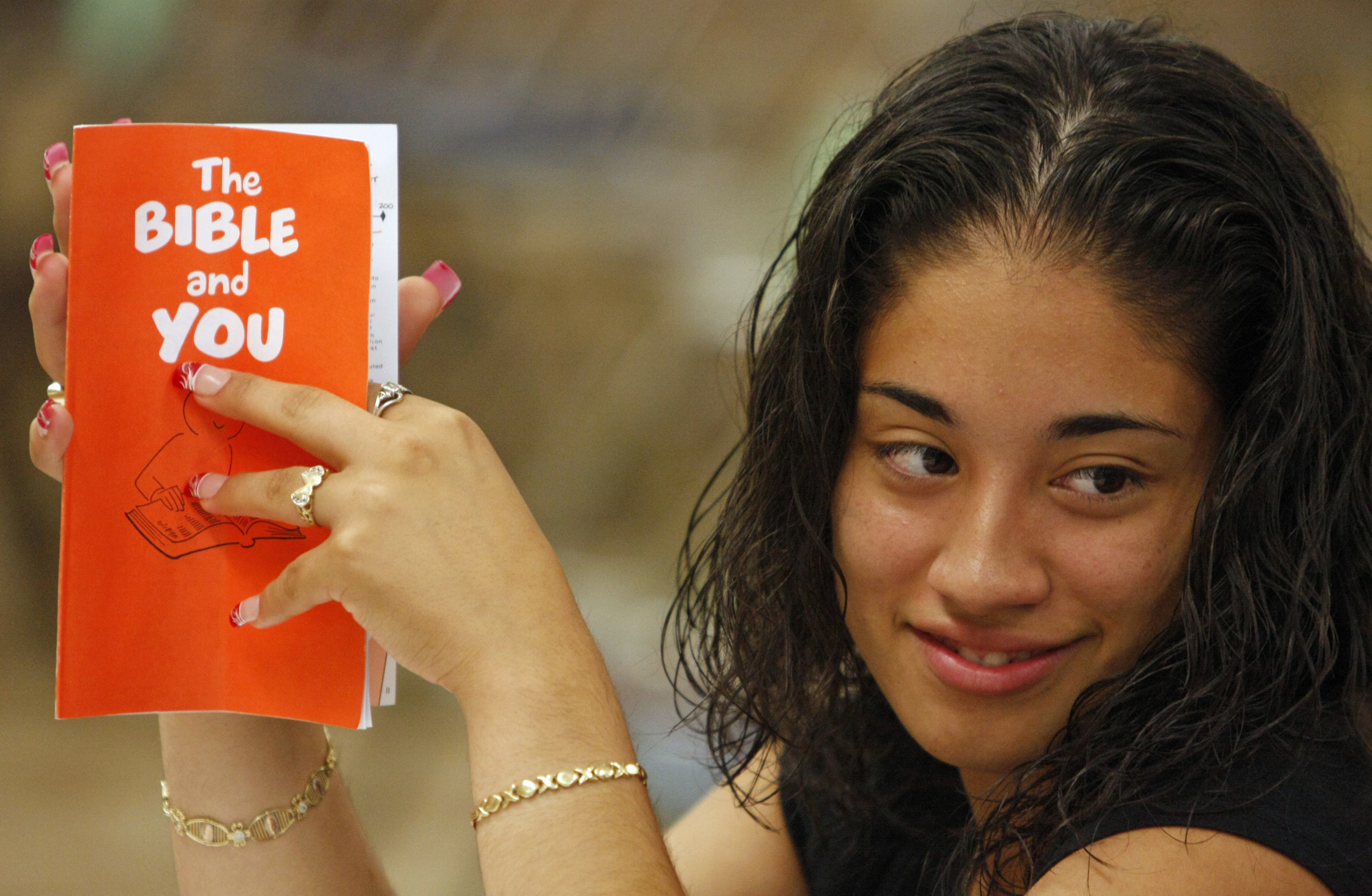 A young woman holds a Bible study guide while attending a New Testament class at St. Luke Church in Brentwood, N.Y. Last year, the American Bible Society showed 57 percent of U.S. adults ages 18 to 28 read their Bible less than three times per year or never. (CNS photo/Gregory A. Shemitz)