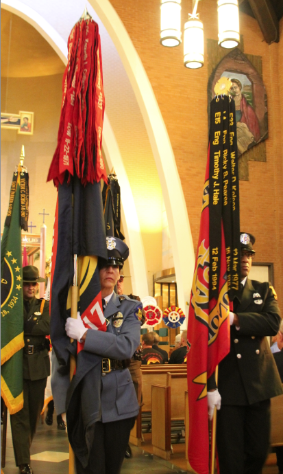 As the 2013 Blue Mass drew to a close, members of law enforcement and fire departments process out carrying the names of those lost in the line of duty on their respective flags. (Ambria Hammel/CATHOLIC SUN)