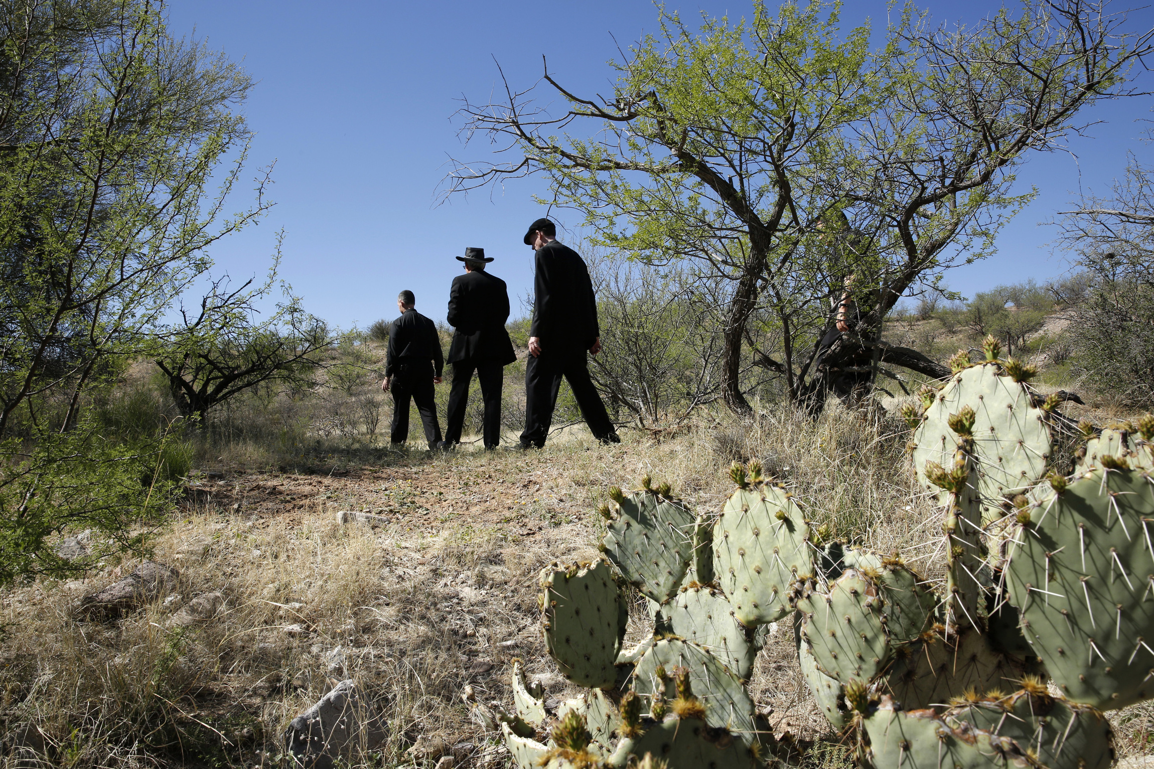 A group of U.S. bishops hikes through the Arizona desert about 30 miles north of Nogales March 31. They were exploring an area where many migrants make their way after illegally crossing into the U.S. from Mexico. The hike was part of two-day tour focused on border issues in Nogales. The tour included an April Mass celebrated in memory of those who have died while crossing the desert. (CNS photo/Nancy Wiechec)