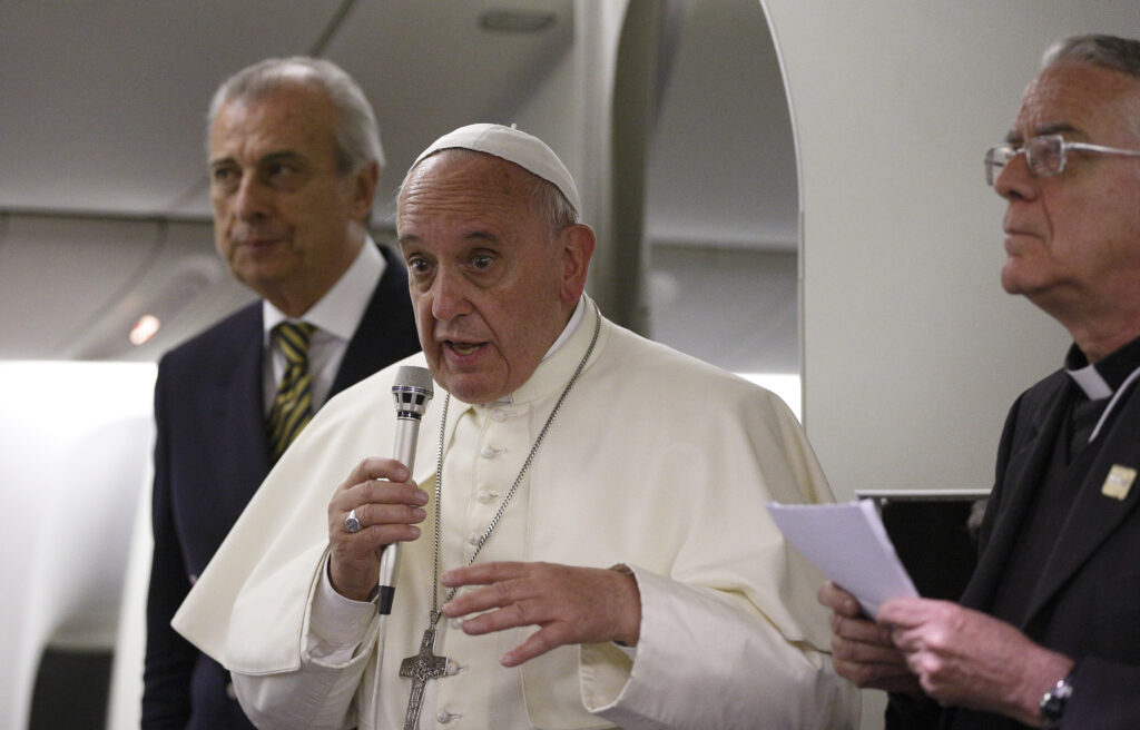 Pope Francis answers questions from journalists aboard the flight from Tel Aviv to Rome May 26. The pope told them he will meet with a group of sex abuse victims for the first time in June and confirmed reports the Vatican is investigating charges its former secretary of state misappropriated 15 million euro from the Vatican bank. (CNS photo/Paul Haring)