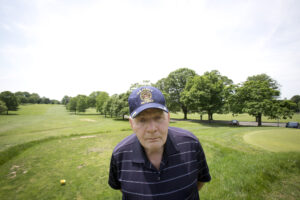 Retired U.S. Navy Master Chief Engineman Ken Faller, 74, poses for a photo on the golf course where he plays regularly at the U.S. Soldiers' and Airmen's Home in Washington. In an interview with Catholic News Service, recalled his tours of duty in Vietnam. For Faller and other veterans, Memorial Day doesn't stand out for them, because they always remember fellow soldiers who died in battle. (CNS photo/Tyler Orsburn) 