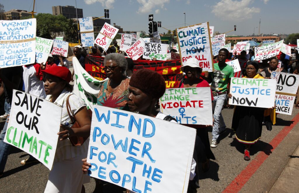 Local residents march in Durban, South Africa, ahead of the international climate talks in this 2011 file photo. Pope Benedict XVI urged leaders to reach a credible agreement on climate change, keeping in mind the needs of the poor and of future generations. (CNS photo/ Siphiwe Sibeko, Reuters)