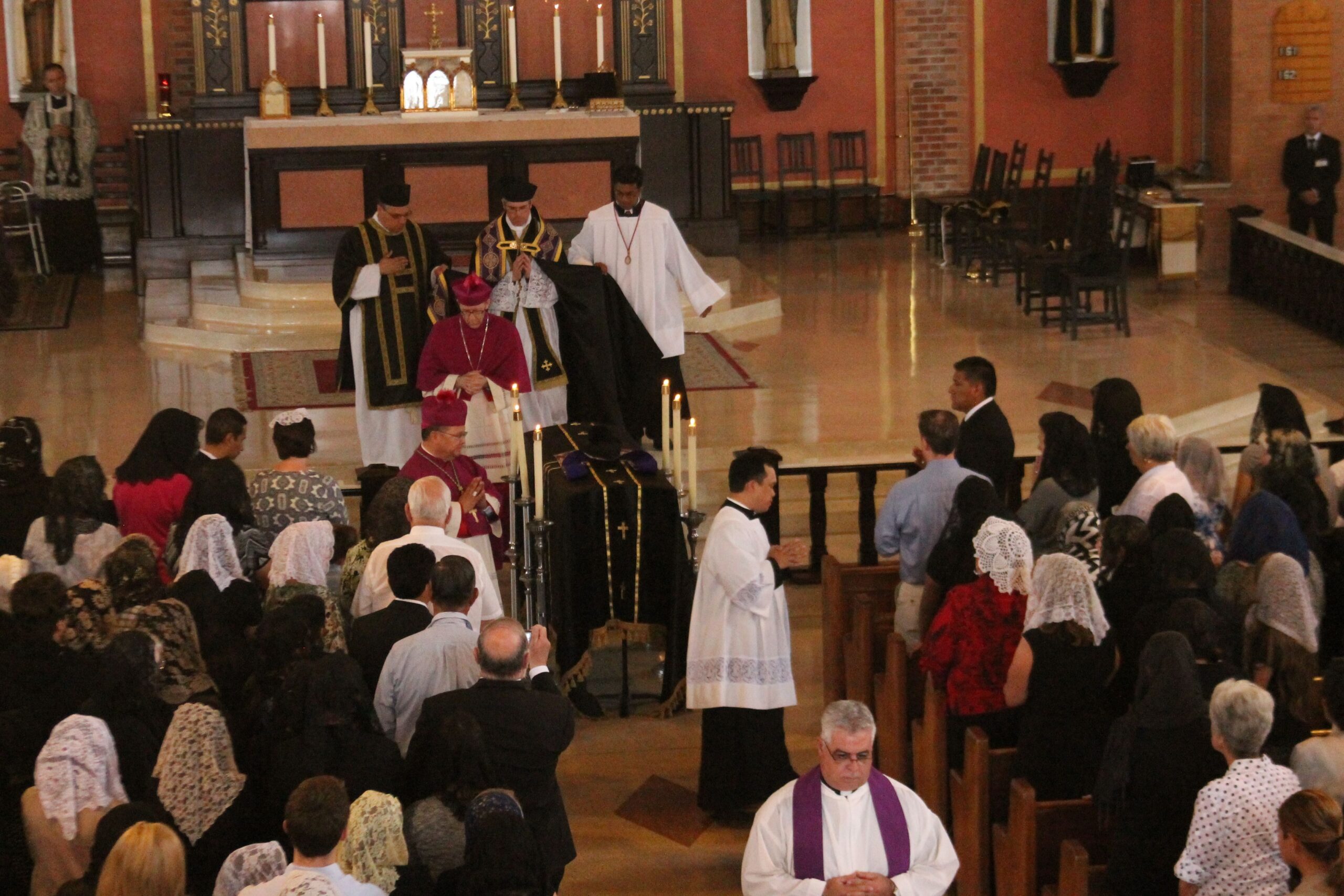 Bishop Thomas J. Olmsted, Auxiliary Bishop Eduardo A. Nevares and Fr. Eric Flood, FSSP, process past the casket of Fr. Kenneth Walker, FSSP, at the requiem Mass June 16 at St. Catherine of Siena Parish in Phoenix. (Joyce Coronel/CATHOLIC SUN)