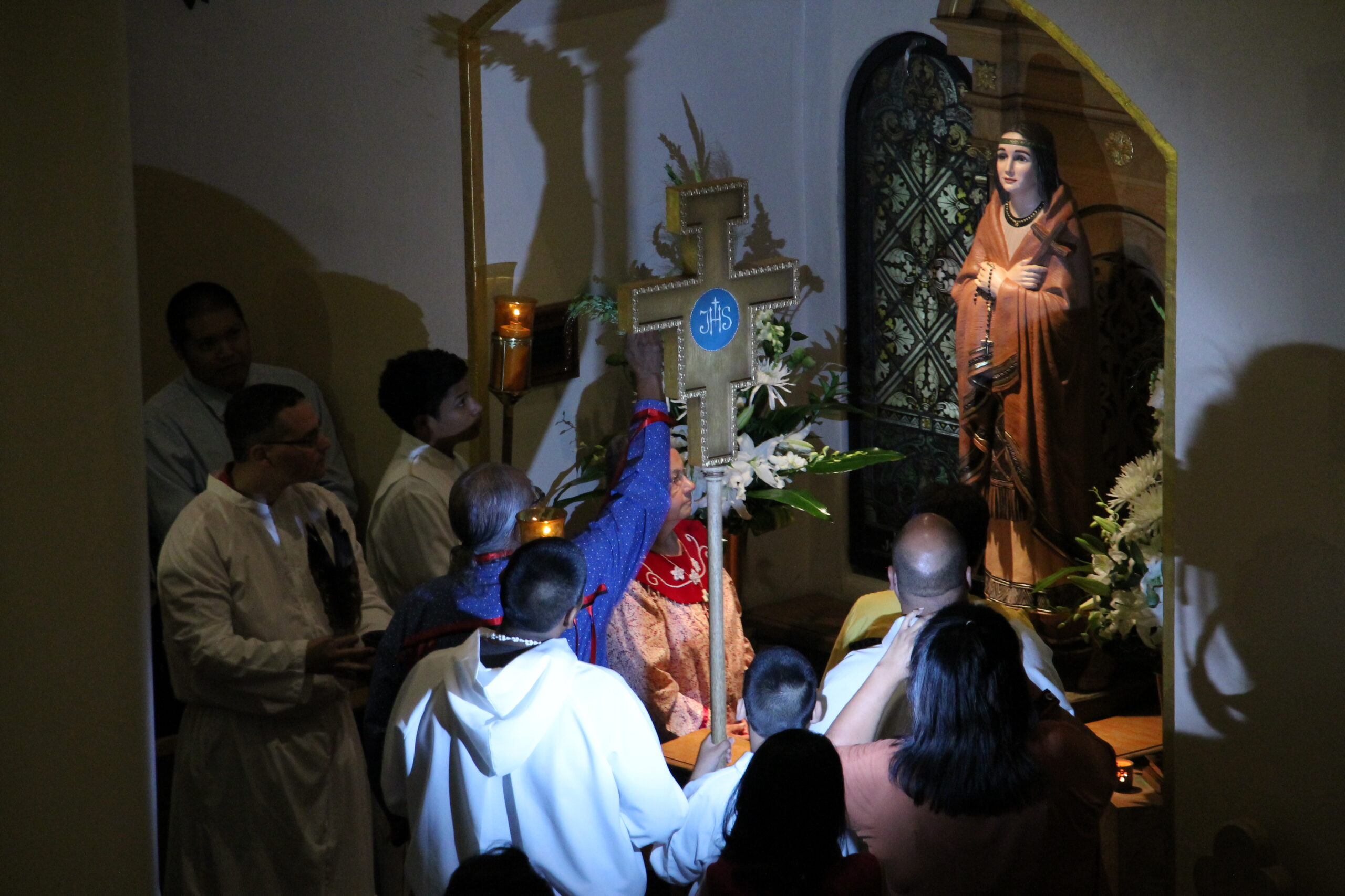 Joseph Enos, an elder in the Native American community, blesses a new statue of St. Kateri Tekakwith at St. Mary's Basilica July 14. Franciscan Father Vince Mesi, pastor, also blessed it. (Ambria Hammel/CATHOLIC SUN)