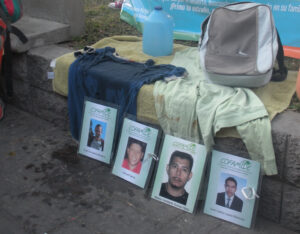 Water, clothes and a backpack, provisions that migrants take during an attempt to cross the border between the U.S. and Mexico are displayed April 11 at the Stations of the Cross in San Salvador. The prayers and meditation focused on the plight of migrants who have perished or disappeared during the dangerous crossing. (CNS photo/Rhina Guidos)