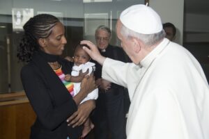 Pope Francis blesses Meriam Ibrahim of Sudan and her baby during a private meeting at the Vatican July 24. The Sudanese woman, who was spared a death sentence for converting from Islam to Christianity and then was barred from leaving Sudan, flew into Rom e July 24 in an Italian government plane. (CNS photo/L'Osservatore Romano via Reuters)