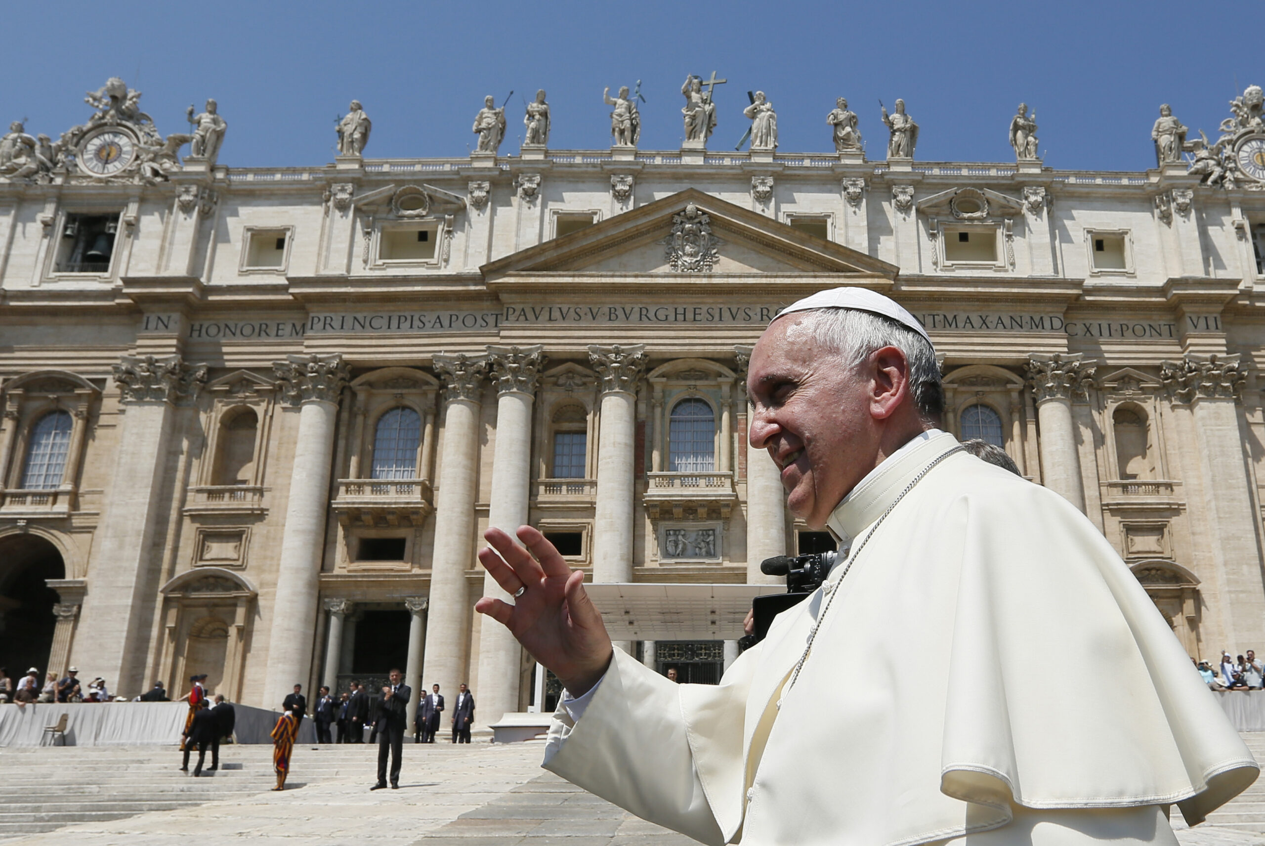 Pope Francis greets the crowd as he leaves his general audience in St. Peter's Square at the Vatican June 11. The pope denounced those responsible for human trafficking, slave labor and arms manufacturing, saying people producing weapons of war are "merchants of death." (CNS photo/Paul Haring)